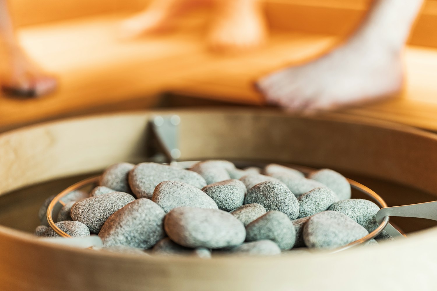Warm stones in a wooden bowl