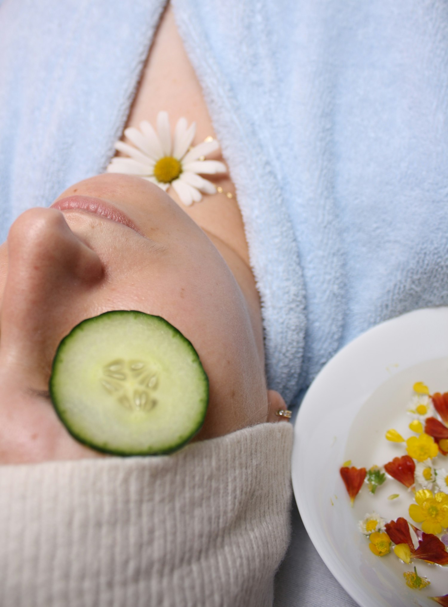 Woman relaxing with cucumber slices over her eyes