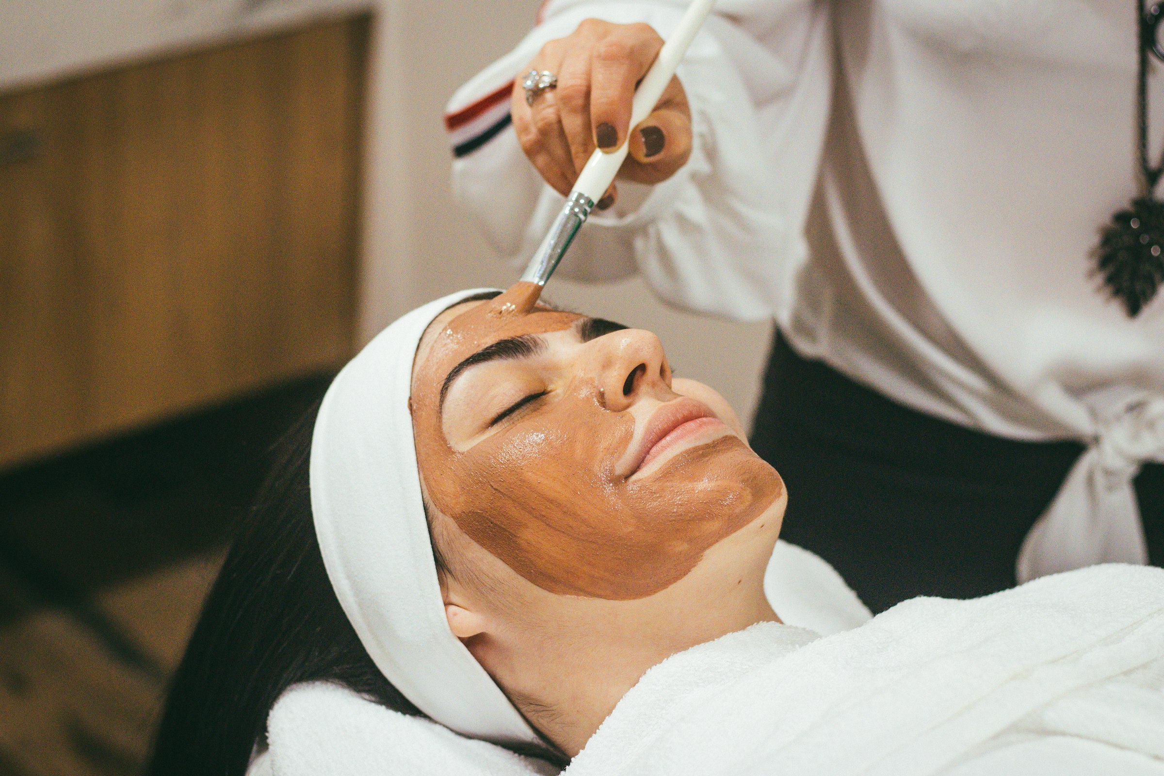 Woman receiving a facial mask treatment